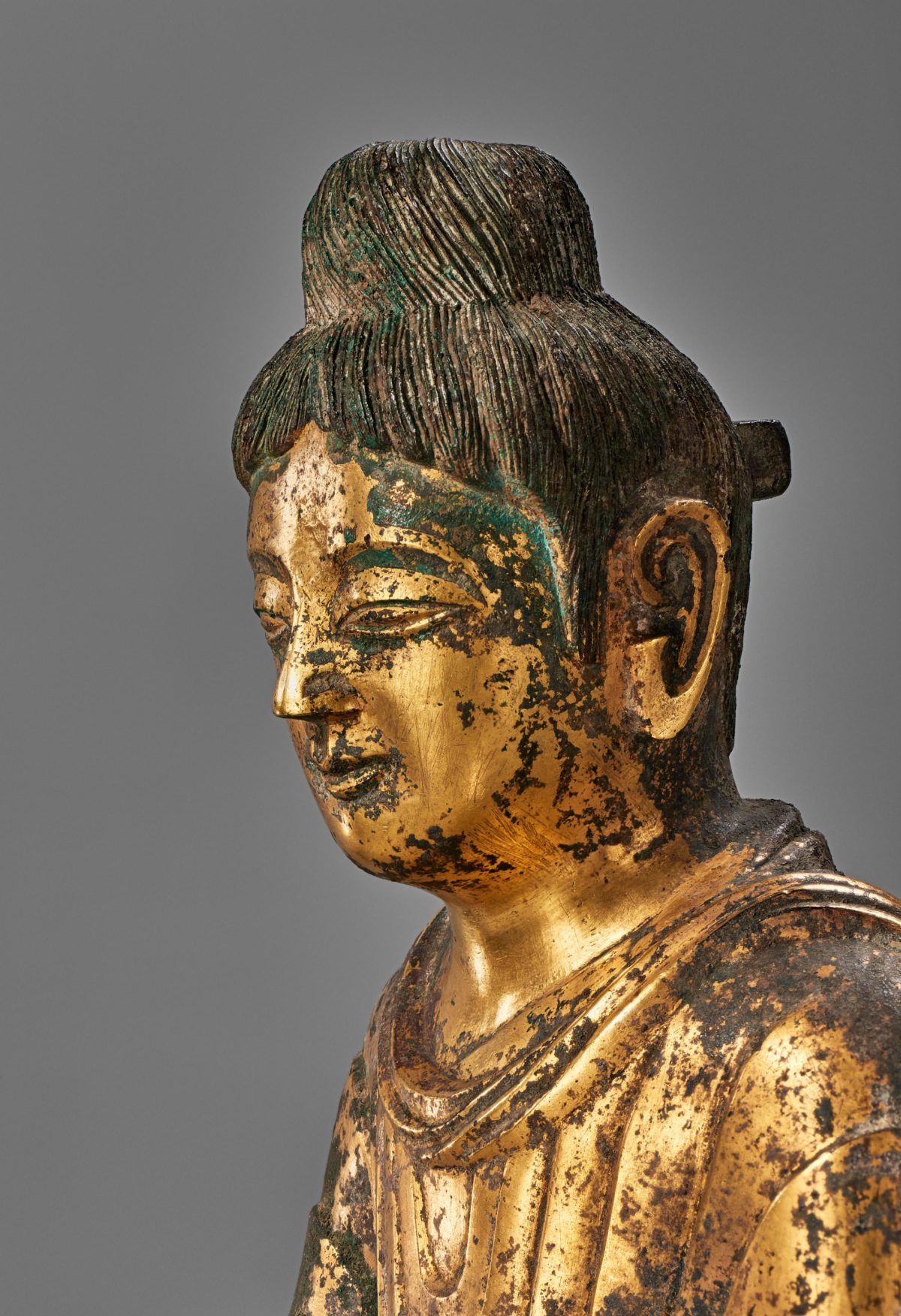 Closeup view of the head of a golden Buddha statue.