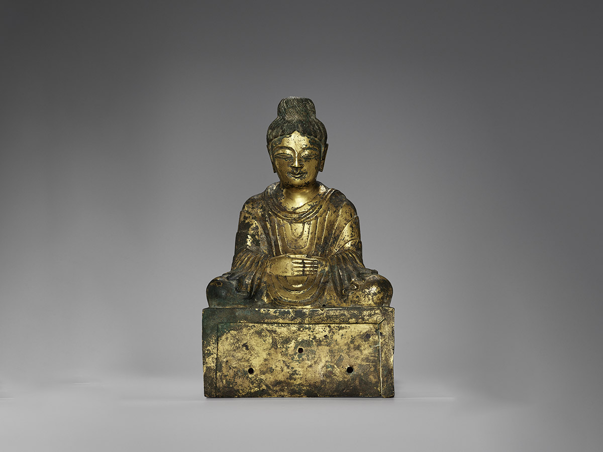 Front view of a golden Buddha statue.