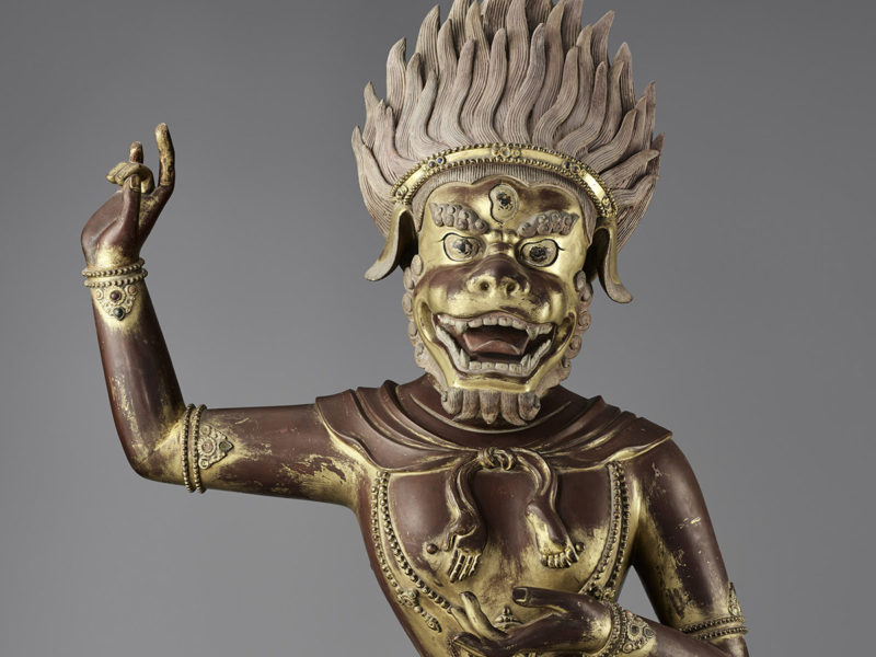 A close-up view of the face of a Buddhist statue, from the chest up